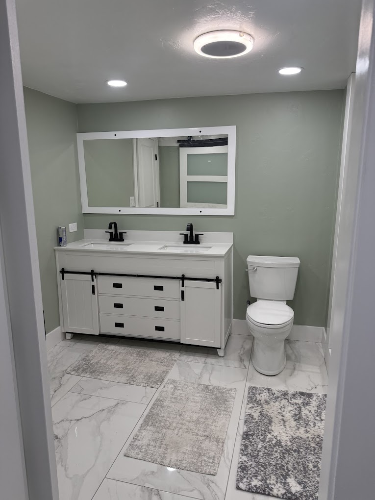 Modern bathroom with double vanity and barn-door cabinetry