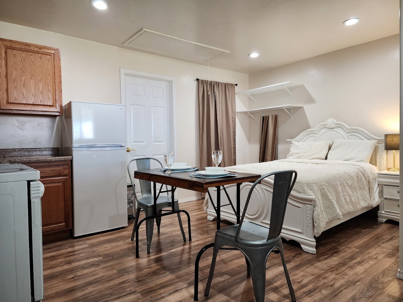 Custom finished interior by Mo Builders LLC, featuring kitchenette, hardwood floors, dining area, and bedroom suite