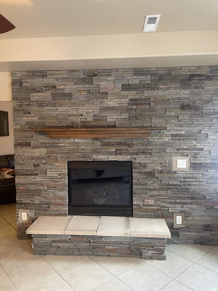 Stacked stone fireplace with custom wood mantel